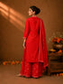 Woman in a Rani red printed Kurti Set with a dupatta, showcasing intricate patterns and elegant drape.