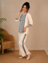 Woman wearing a cream kurta with blue paisley print, showcasing intricate embroidery and a band collar neckline.