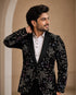 A classic black taxido suit, perfect for formal events, showcasing elegant tailoring and a sophisticated look.