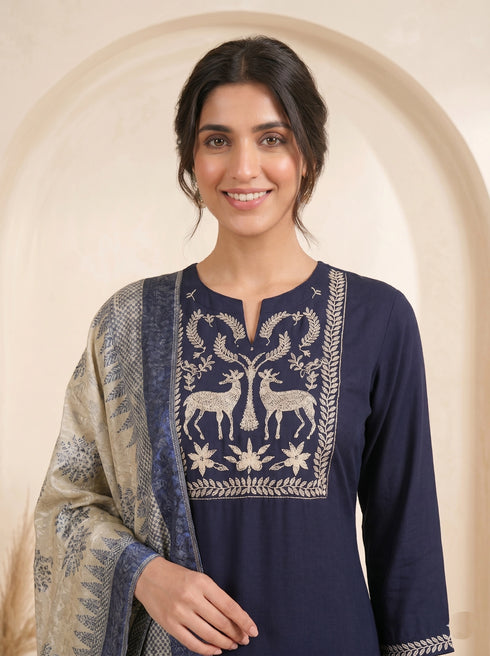 Navy blue embroidered kurti and pants set with a printed dupatta draped over the shoulder.