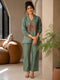 Woman wearing a Pista green co-ord set with a tree ring print top and textured pants.