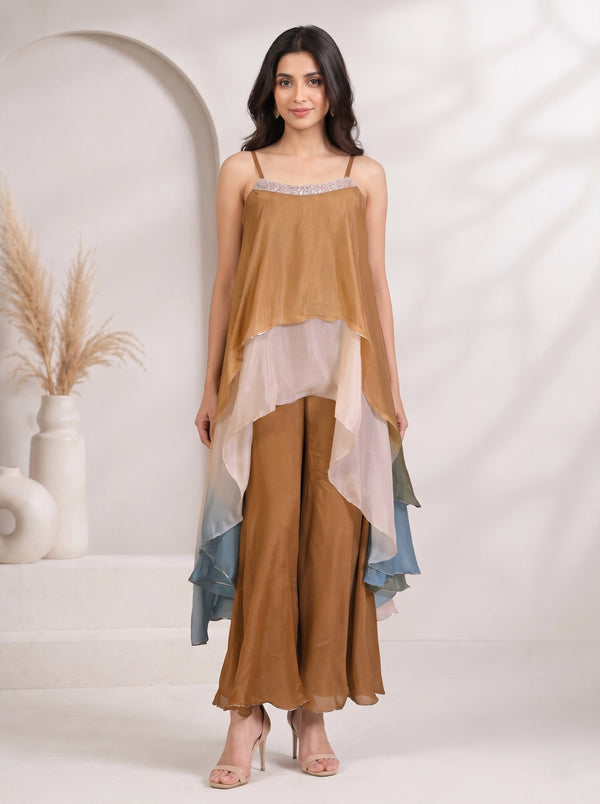 Woman wearing a brown layered chiffon palazzo suit with a sequined neckline and flowing sleeves.