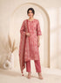Woman wearing a rose pink printed kurti set with a dupatta, featuring leaf motifs and striped patterns.