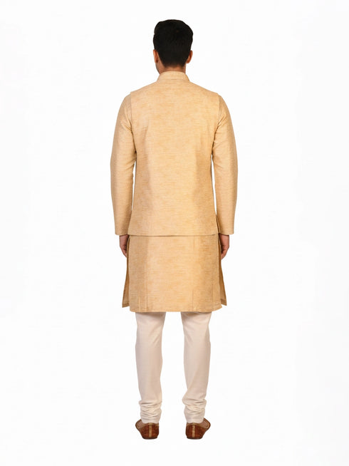 Man wearing a beige embroidered kurta jacket set with golden floral patterns, suitable for festive occasions.