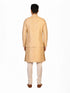 Man wearing a beige embroidered kurta jacket set with golden floral patterns, suitable for festive occasions.