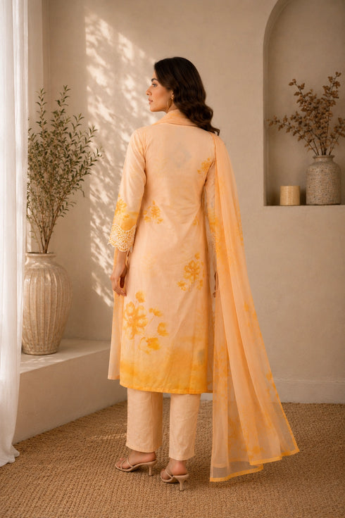 Woman wearing a yellow floral embroidered Kurti Set with lace trim and matching dupatta.