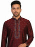 Man wearing a maroon kurta with a diamond pattern and embroidered neckline, paired with cream pants.