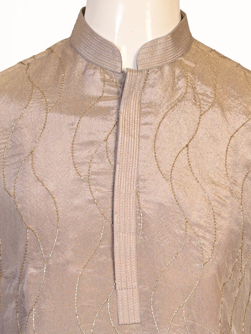 Man wearing a multi-color textured kurta with shimmering accents and cream pants, ready for festive occasions.