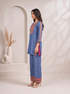 Woman wearing a blue embroidered kurta and matching wide-leg pants with a geometric border, styled with nude heels.