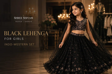 Young girl wearing a black Indo-Western lehenga with elegant embroidery, posing in a luxurious wedding venue for festive party wear styling inspiration.