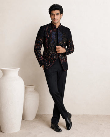 Man wearing an elegant navy blue Jodhpuri suit, a traditional Indian formal outfit.