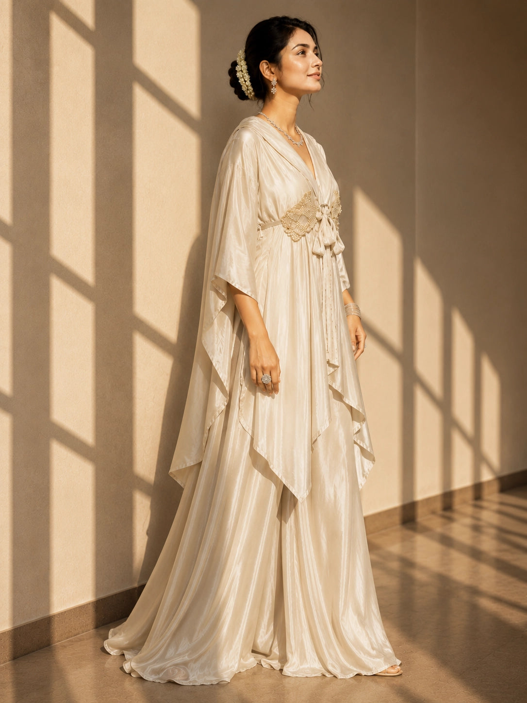 Woman in elegant beige kaftan-style kurti with embellished waist and wide-leg palazzo pants.