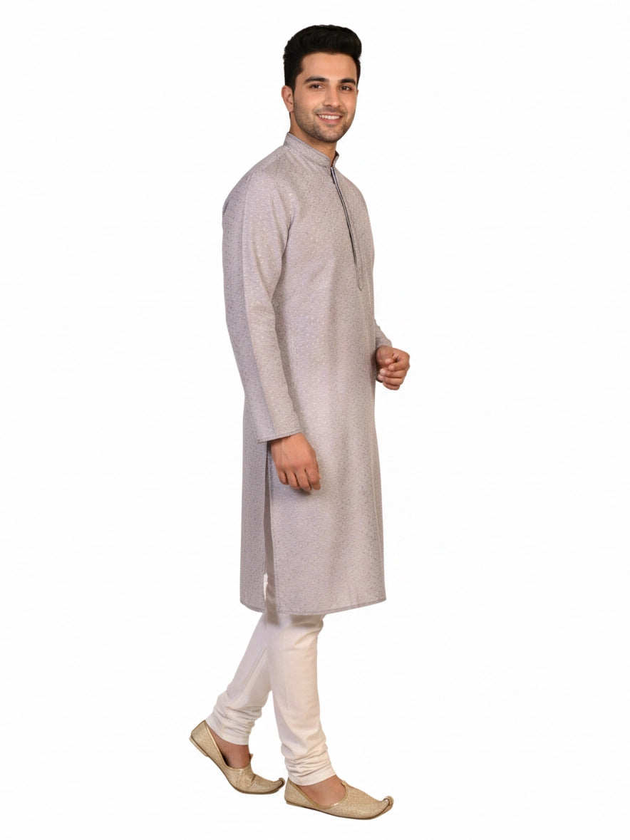 Man wearing a grey Kurta Pajama with a subtle geometric pattern and cream churidar pants.