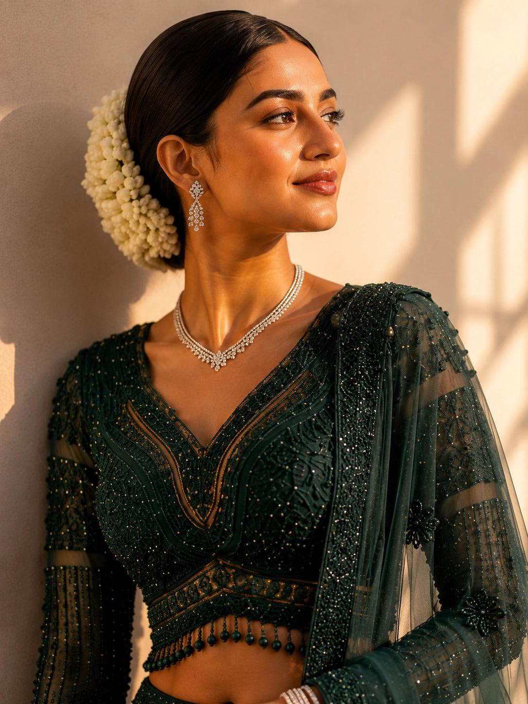Woman in an exquisite dark green heavily embellished  INDO lehenga choli set.