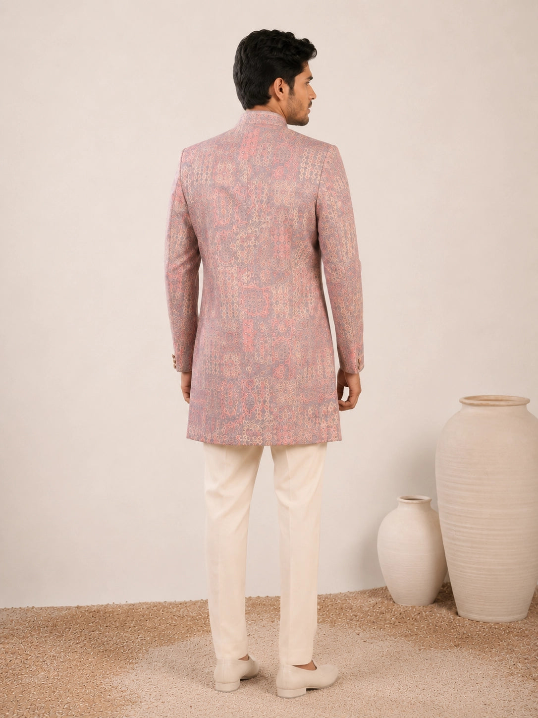 Model wearing an elegant purple Indowestern gown with delicate embroidery, front view.