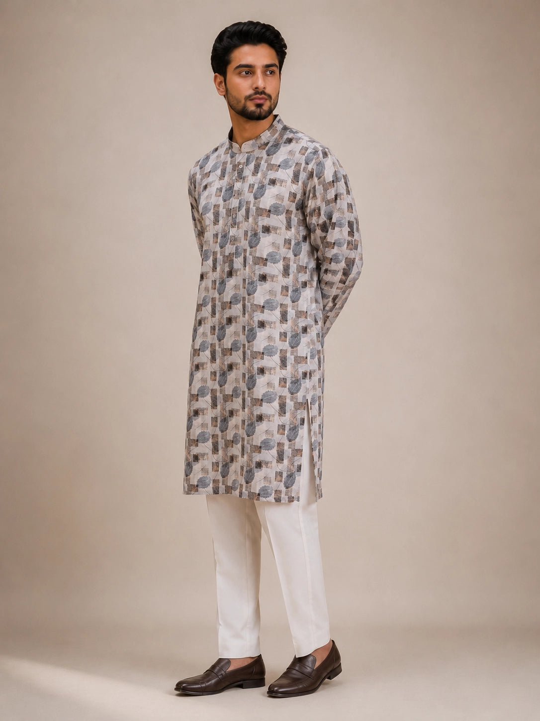 Man wearing an ice grey printed kurta with white pajama and brown loafers.