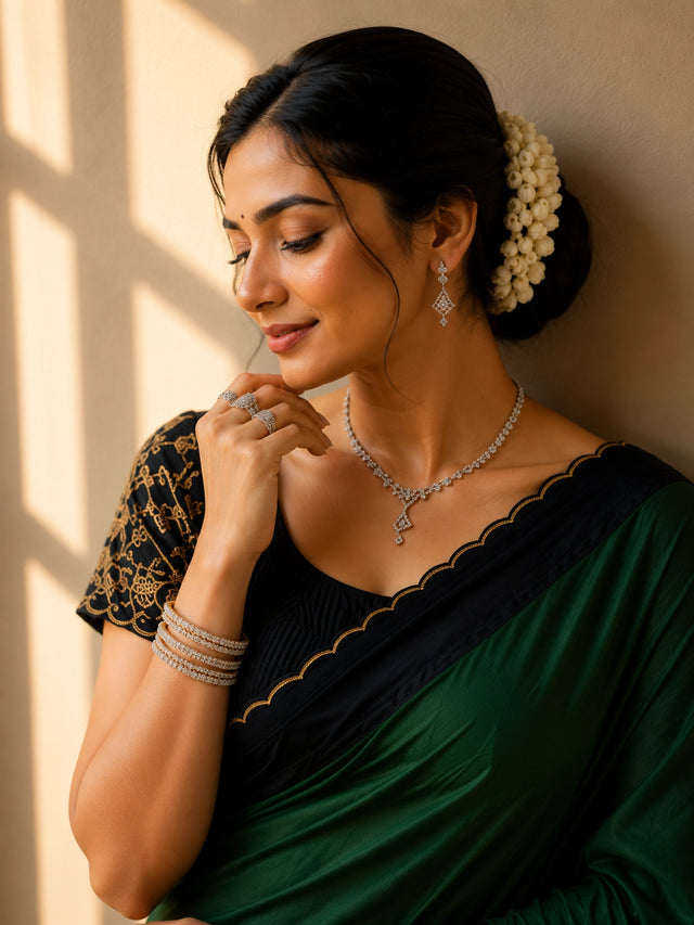 Elegant saree in grey with black scalloped border and gold trim.