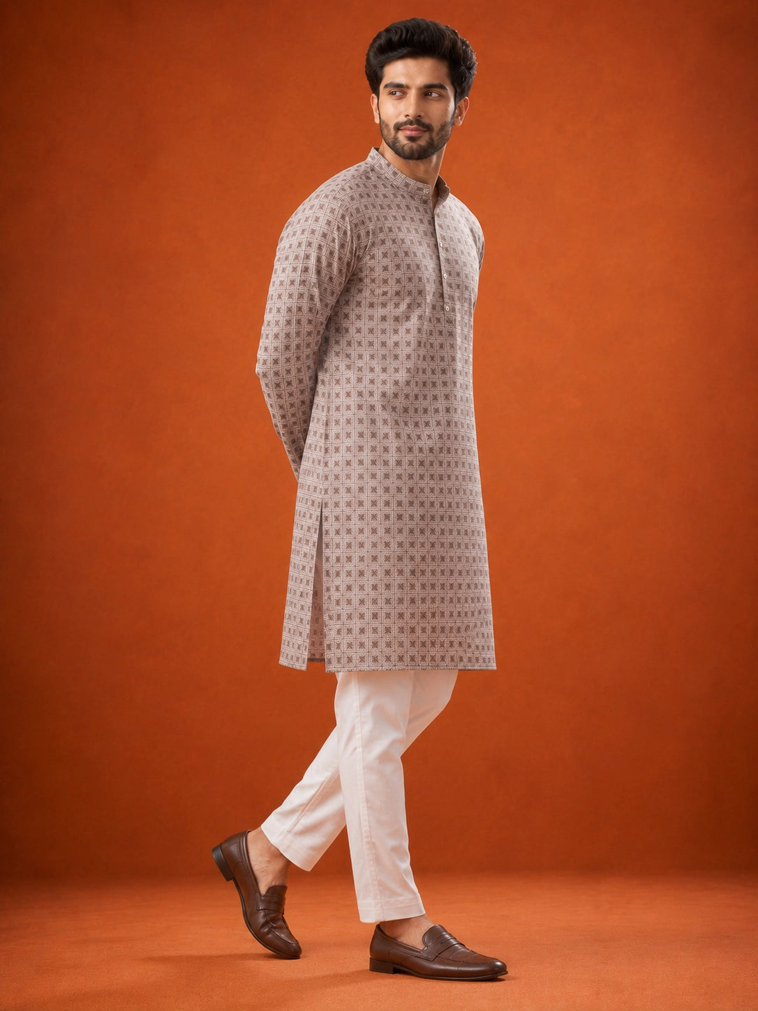 Man wearing P.IVORY geometric print kurta with white pajama and brown loafers.