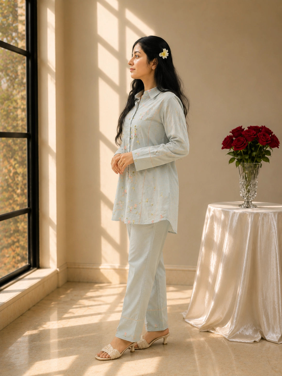 Woman in sky blue floral embroidered kurta set with matching pants.