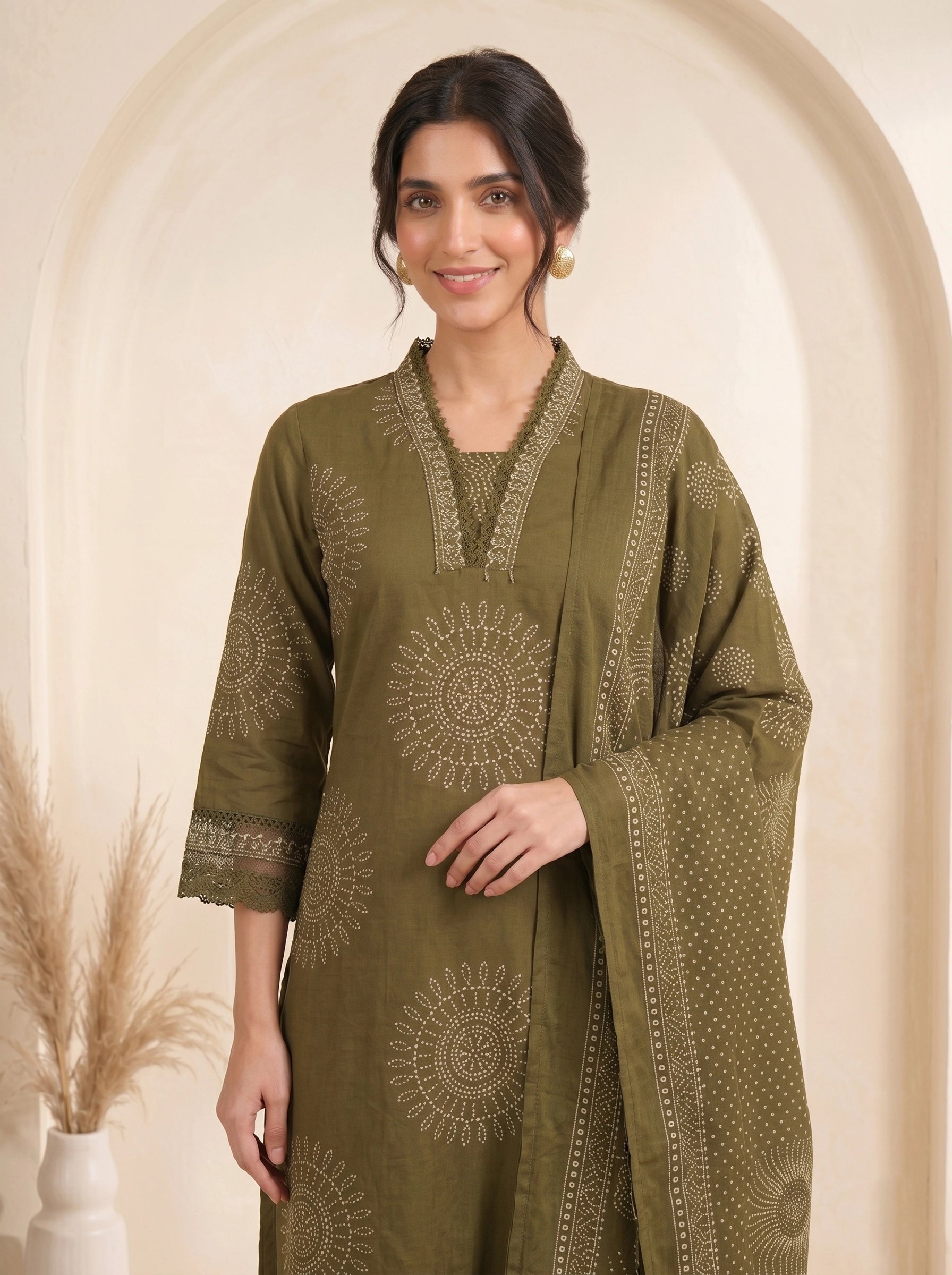 Woman wearing an olive green printed kurti with palazzo pants and a dupatta, styled for a casual or festive occasion.