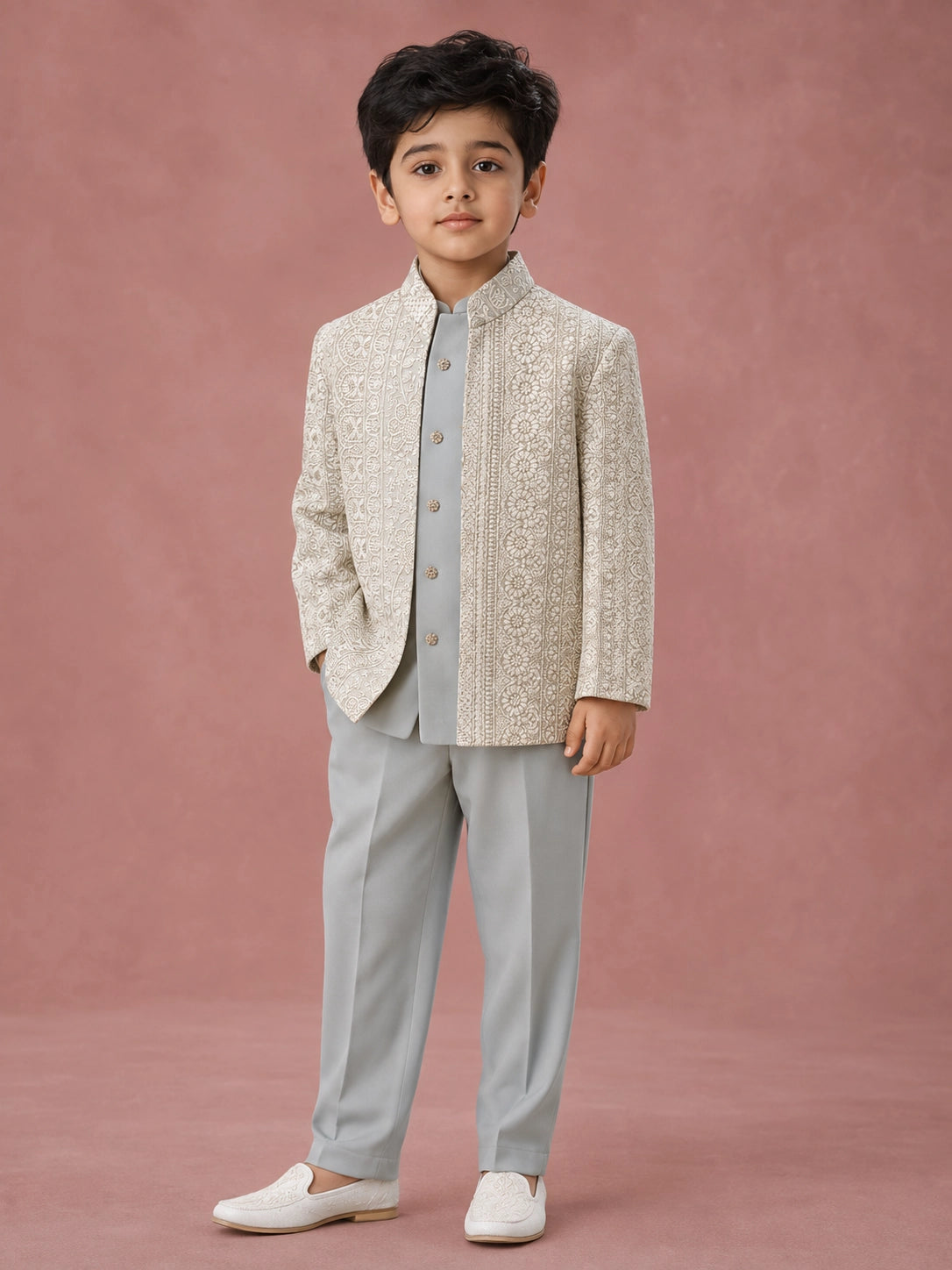 Young boy wearing a pista green Indo-Western suit with an intricately embroidered jacket.
