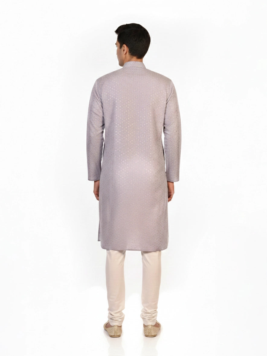 Man wearing a grey Kurta Pajama with a subtle geometric pattern and cream churidar pants.