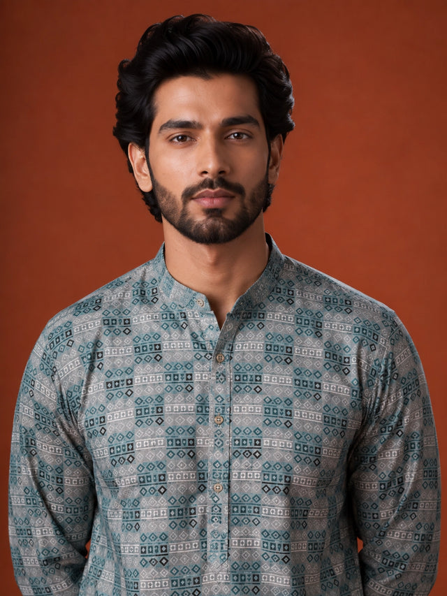 Man wearing a green and grey checkered kurta with white pajama and brown loafers.