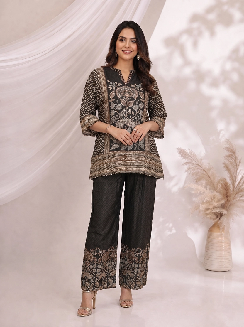 Woman wearing a black printed kurta with wide-leg pants, featuring floral motifs and a contrasting border.