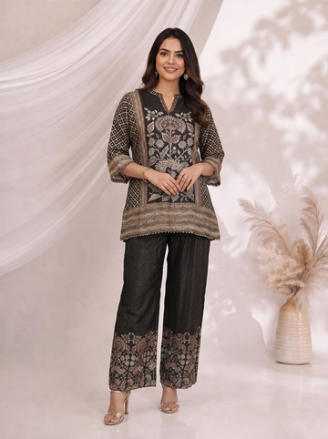 Woman wearing a black printed kurta with wide-leg pants, featuring floral motifs and a contrasting border.