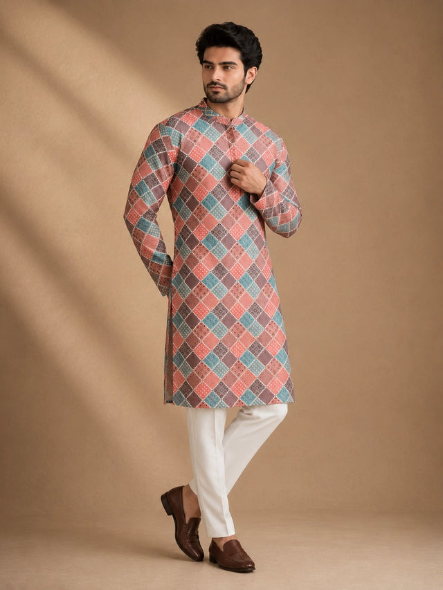 Man in a vibrant geometric diamond print kurta, white pajama, and brown loafers.