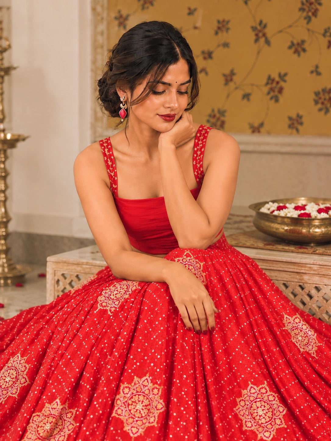 Vibrant red embroidered lehenga choli set with gold patterns and scalloped dupatta.