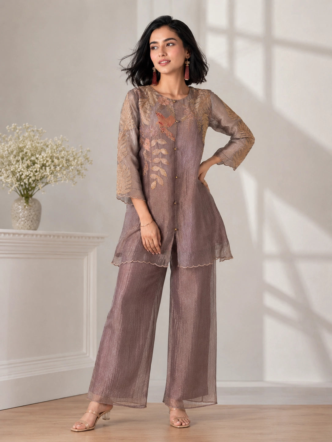 Woman wearing a brown embroidered Sharara with leaf motifs and a bird detail, perfect for festive occasions.