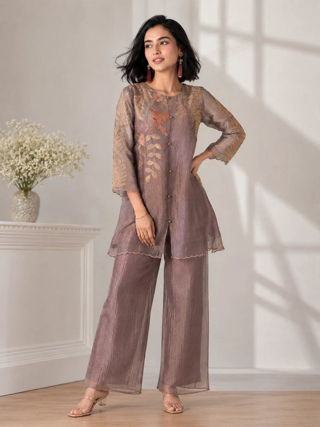 Woman wearing a brown embroidered Sharara with leaf motifs and a bird detail, perfect for festive occasions.