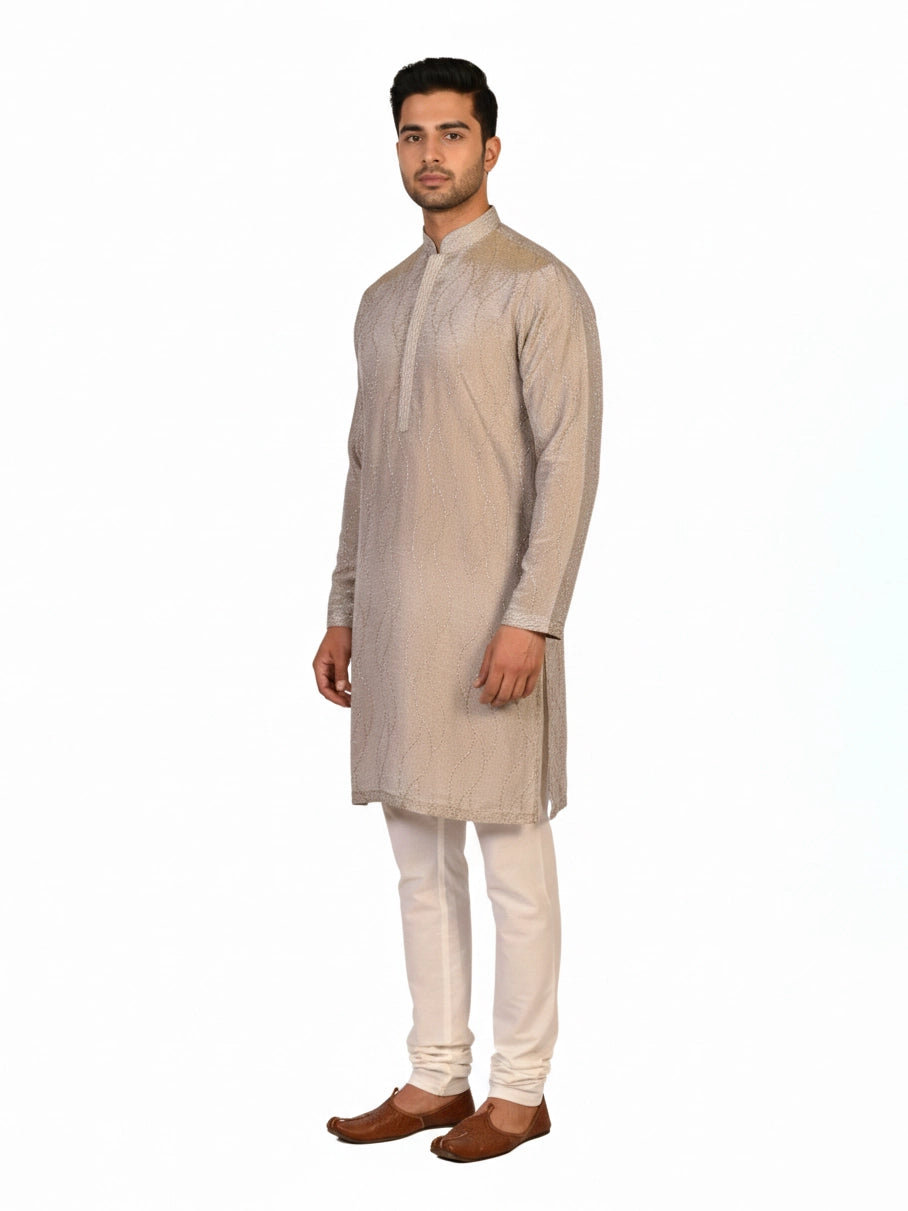 Man wearing a multi-color textured kurta with shimmering accents and cream pants, ready for festive occasions.