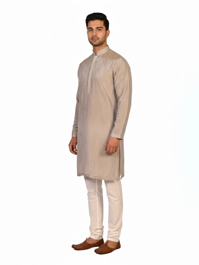 Man wearing a multi-color textured kurta with shimmering accents and cream pants, ready for festive occasions.