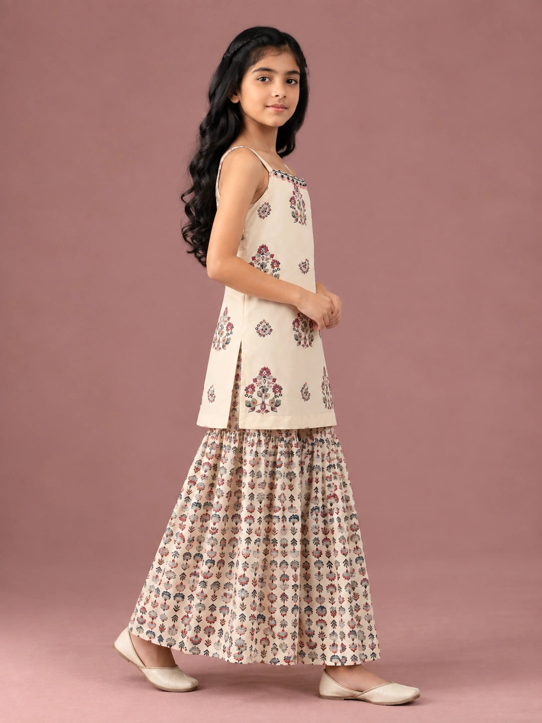 Young girl in a cream floral print strappy top and matching flared sharara set.