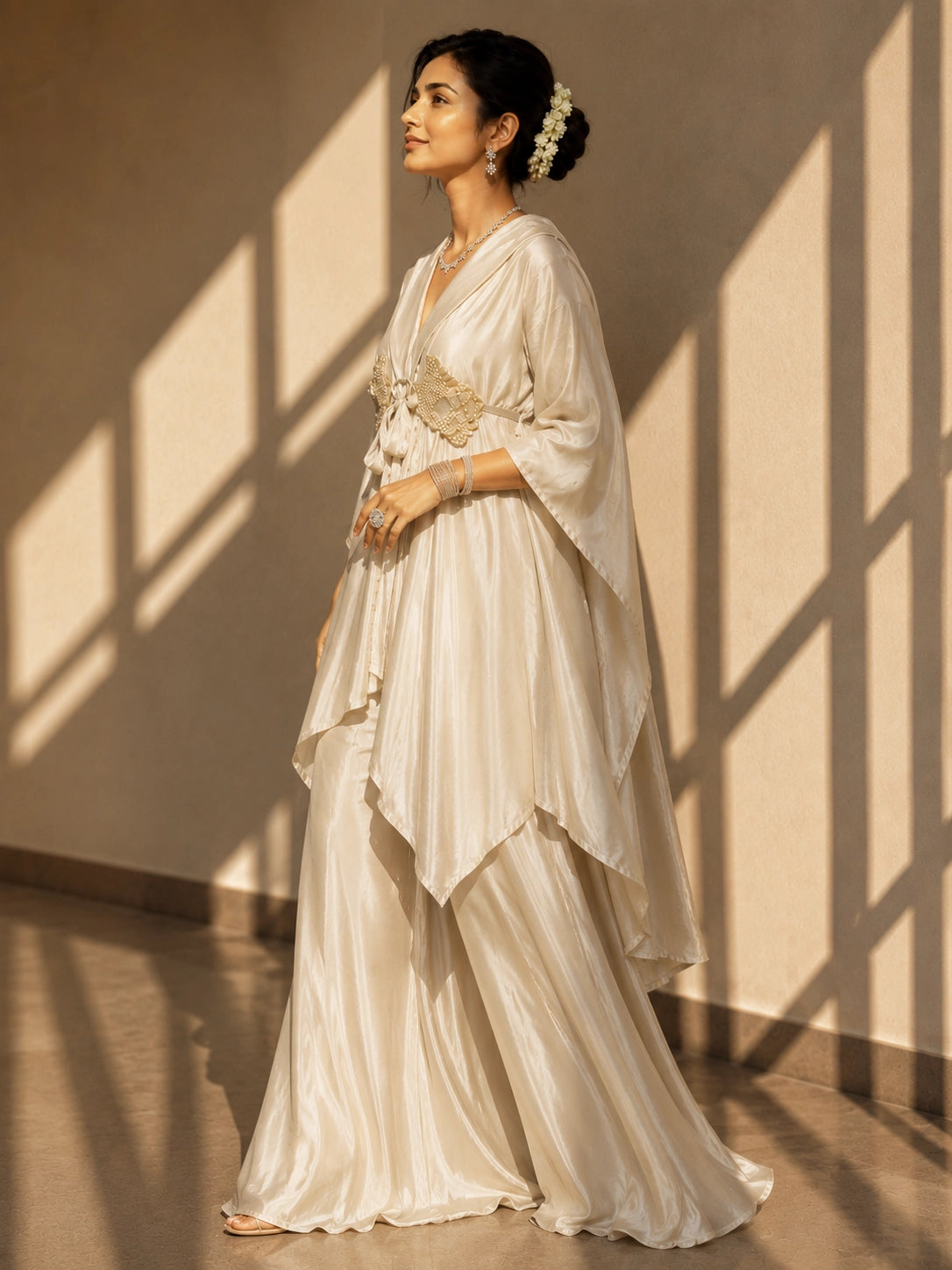 Woman in elegant beige kaftan-style kurti with embellished waist and wide-leg palazzo pants.