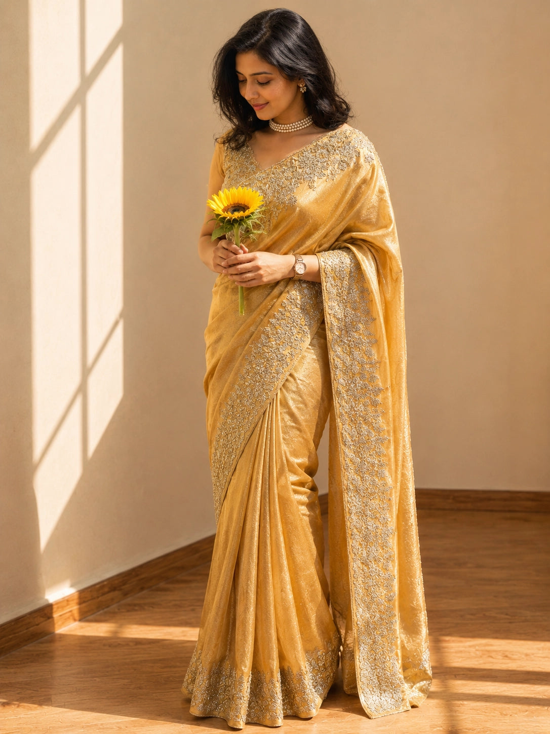 Beautiful woman wearing a luxurious mustard S3 saree with delicate gold embroidery.