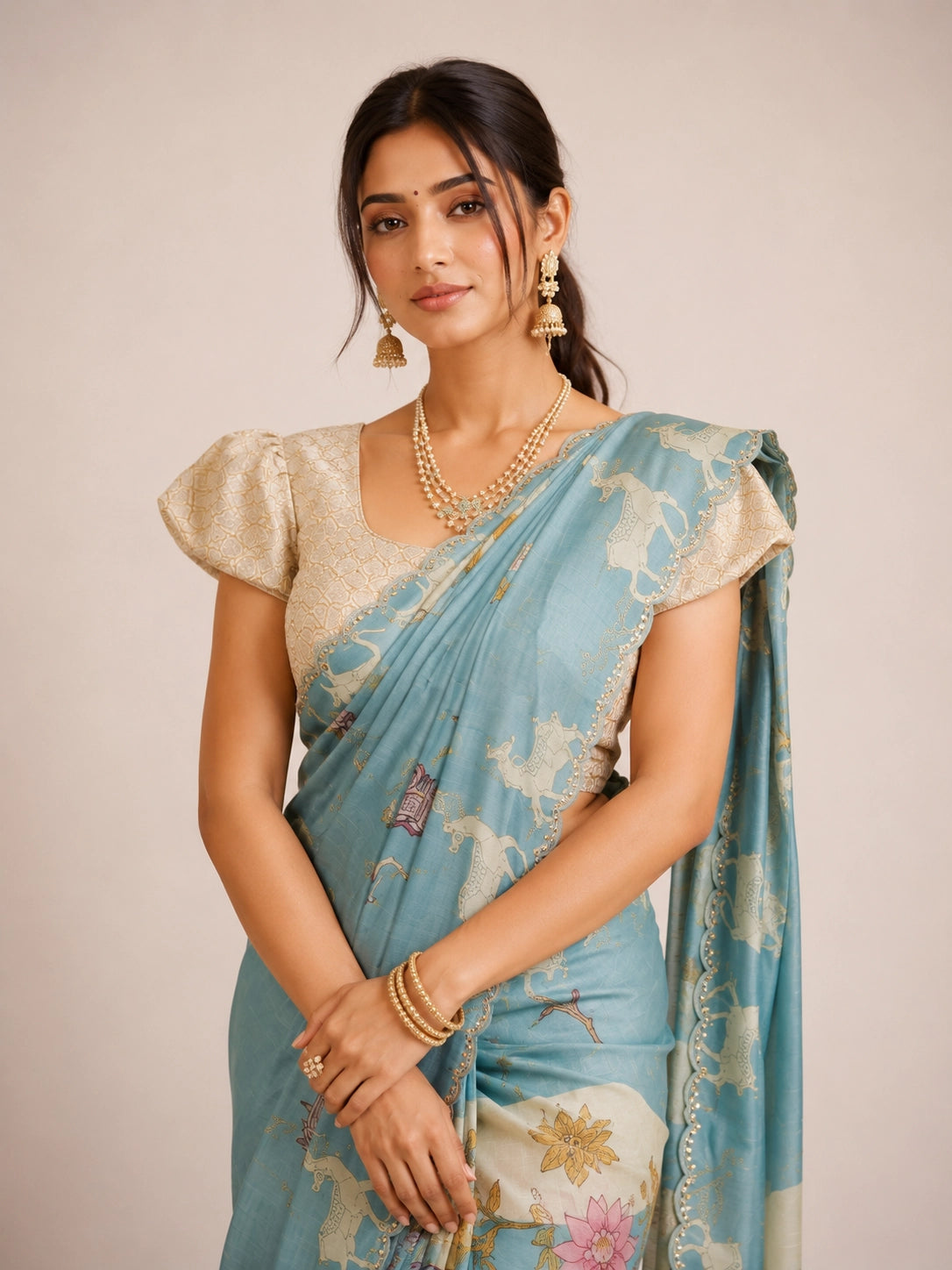 Woman in an elegant sky blue  floral saree with a cream textured blouse.