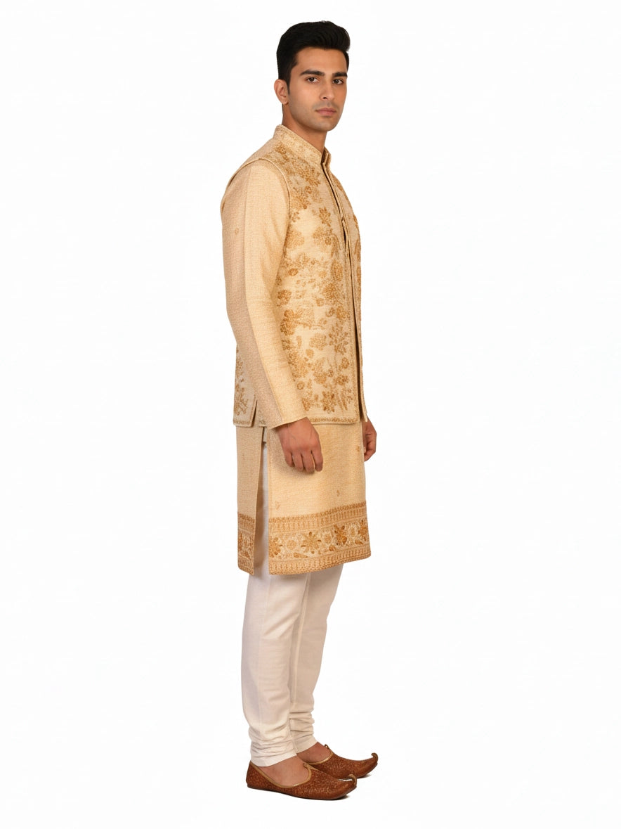 Man wearing a beige embroidered kurta jacket set with golden floral patterns, suitable for festive occasions.