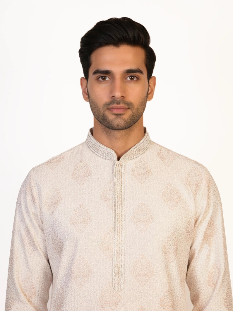 Man wearing a multi-color embroidered kurta and white pants, traditional Indian ethnic wear.