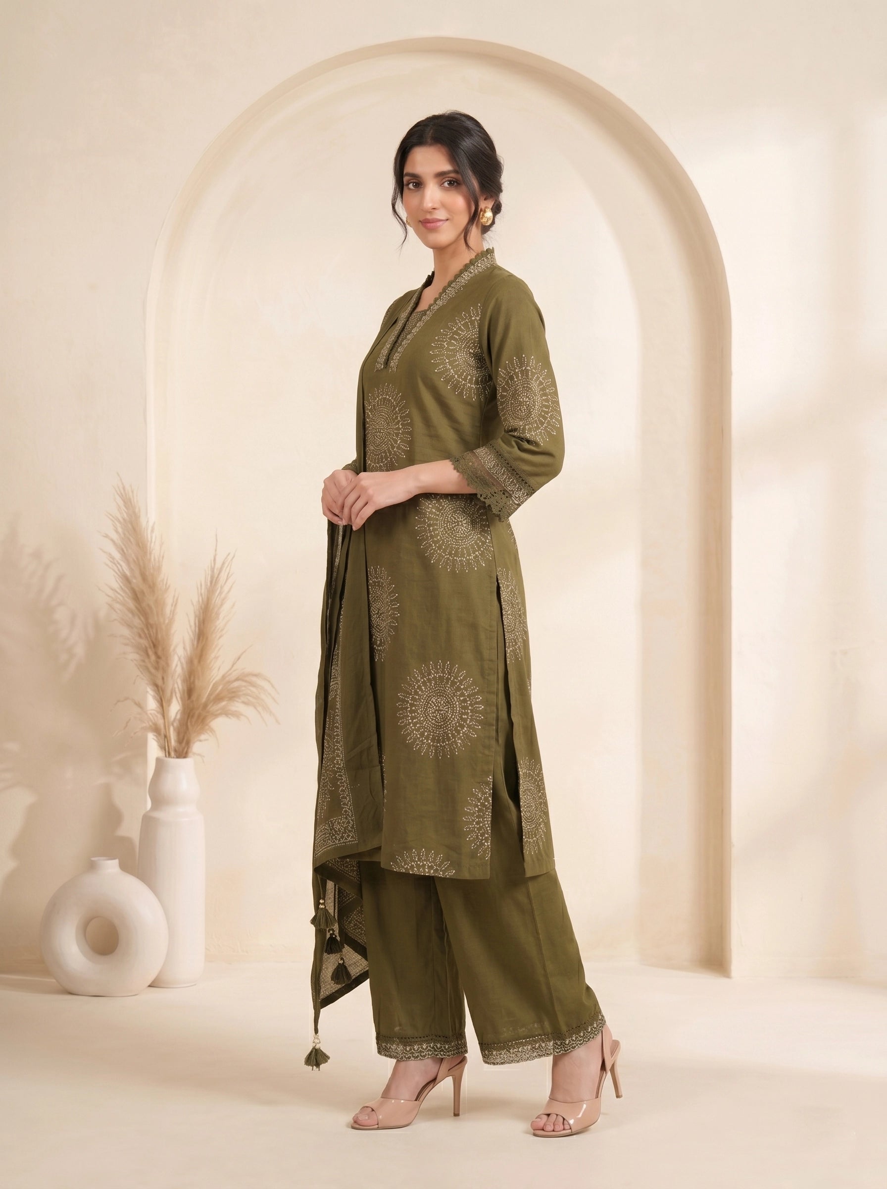 Woman wearing an olive green printed kurti with palazzo pants and a dupatta, styled for a casual or festive occasion.