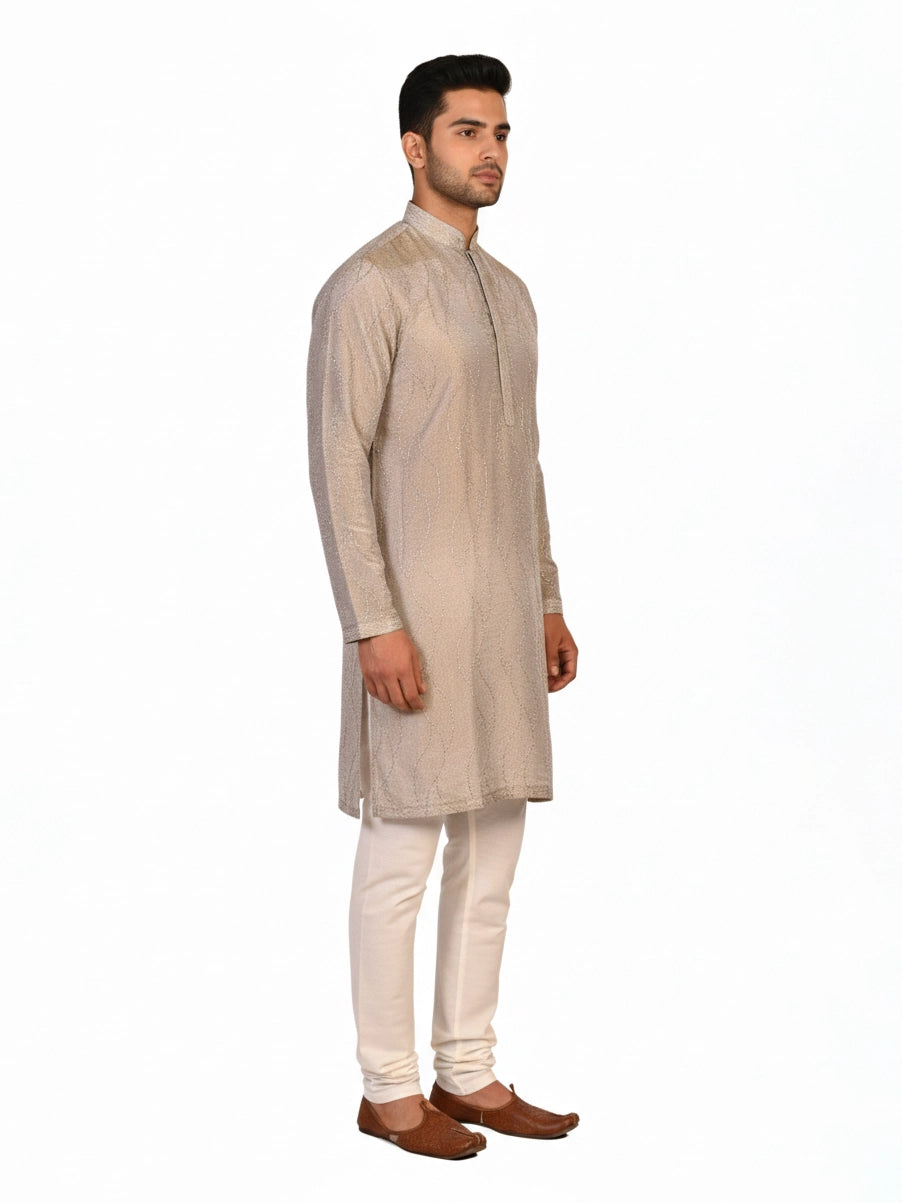 Man wearing a multi-color textured kurta with shimmering accents and cream pants, ready for festive occasions.