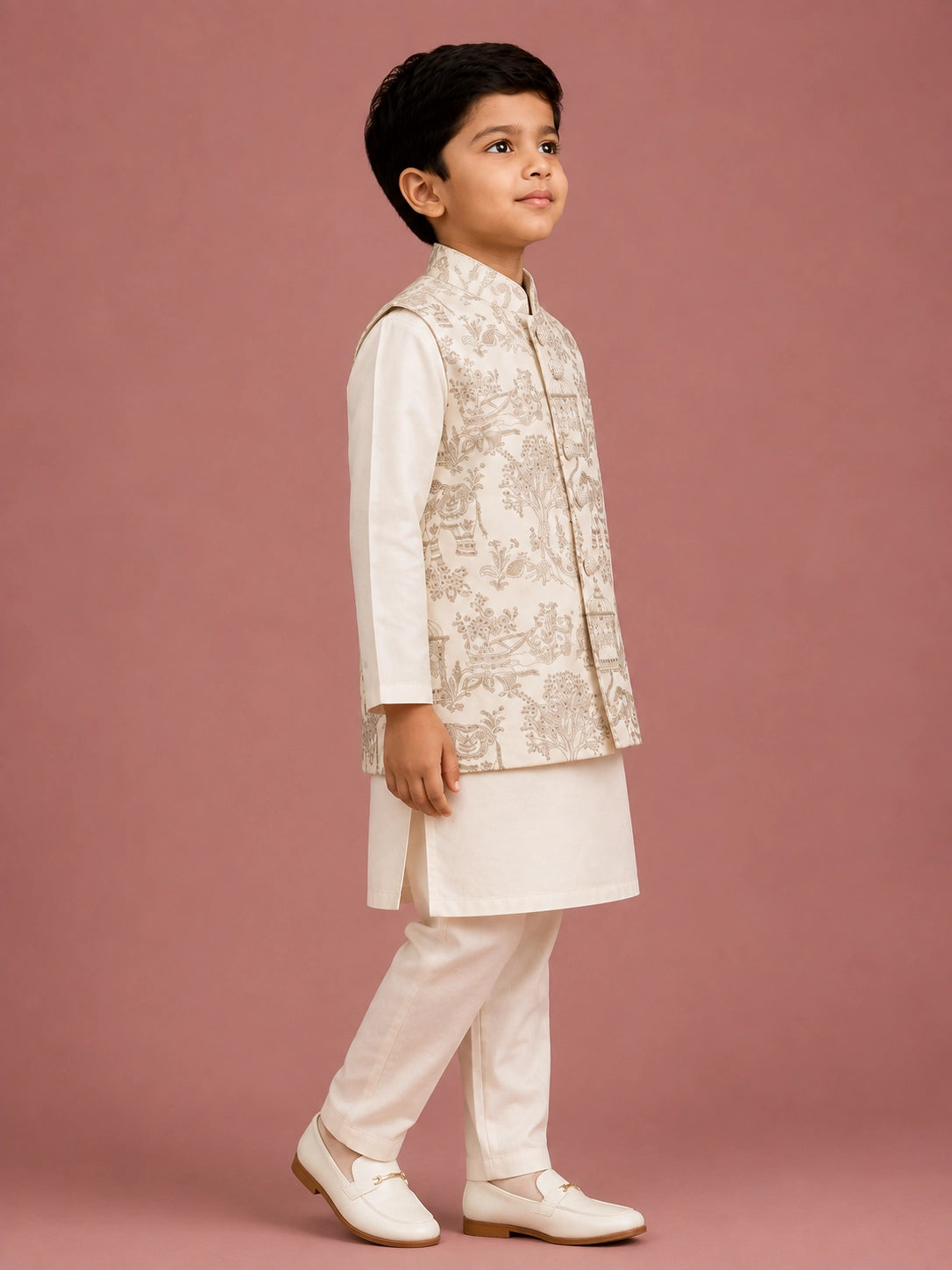 Young boy wearing an off-white embroidered bandhgala waistcoat over a kurta pajama.