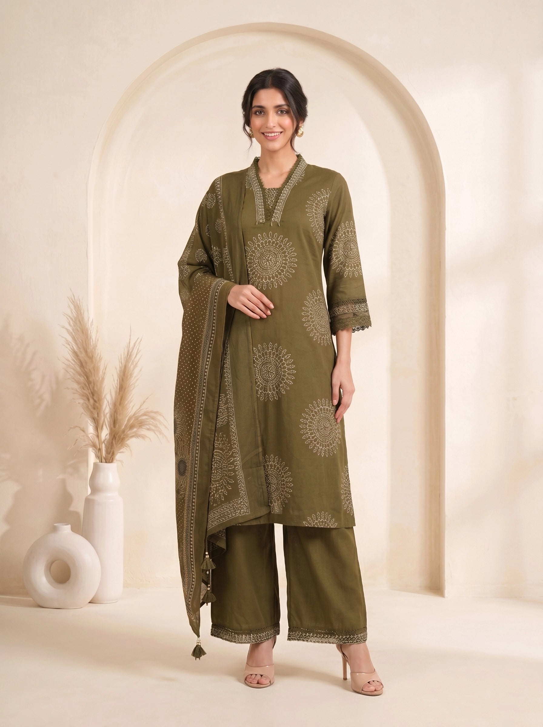 Woman wearing an olive green printed kurti with palazzo pants and a dupatta, styled for a casual or festive occasion.