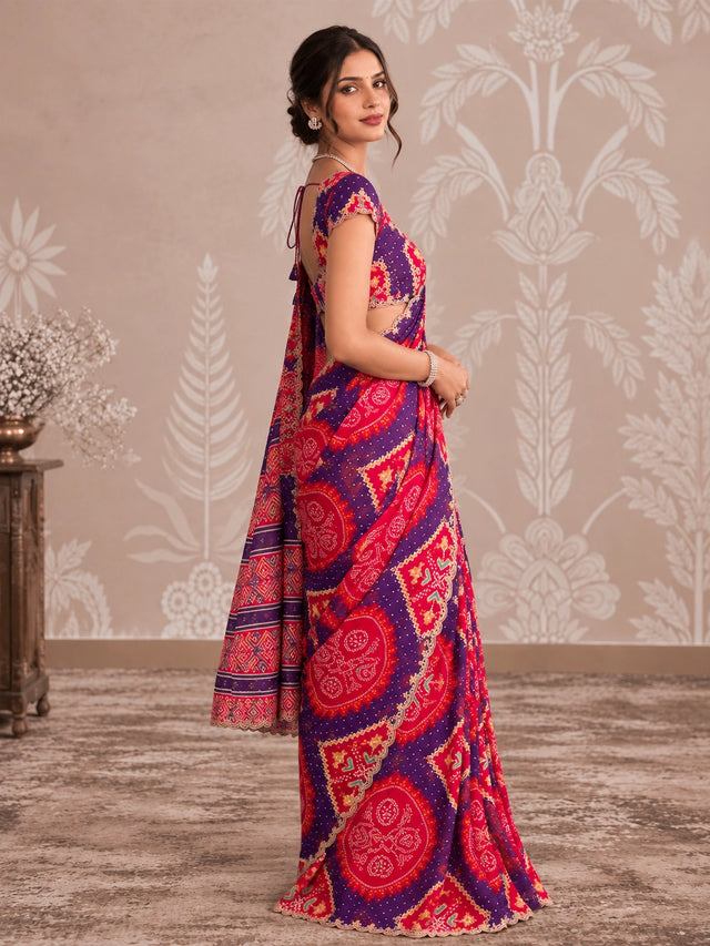 Woman in vibrant purple and pink printed saree with intricate patterns and scalloped border.
