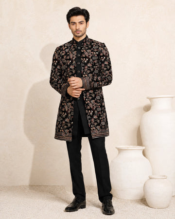 Man wearing a stylish black Indo-Western suit, showcasing modern Indian ethnic wear.