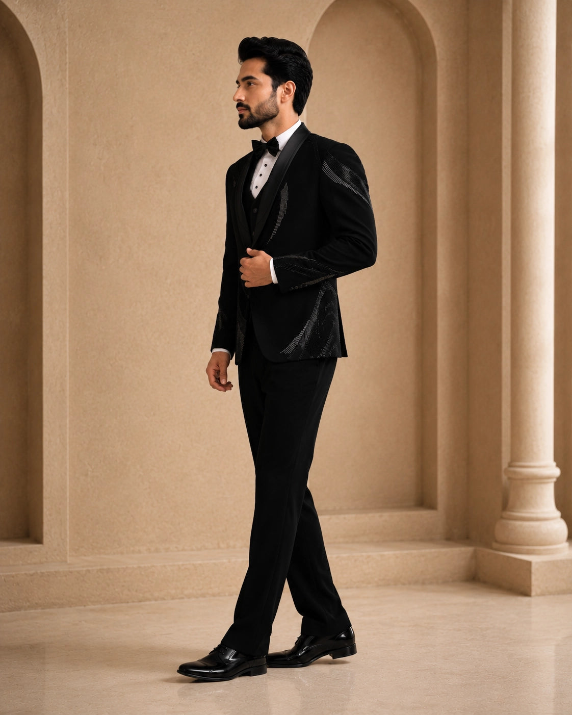 A classic black taxido suit for men, showcasing a sharp silhouette and elegant formal wear.