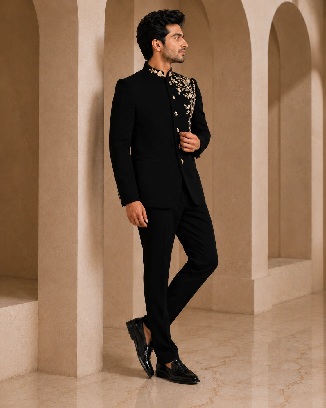 Man wearing a classic black Jodhpuri suit, a traditional Indian formal outfit.