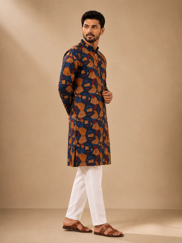 Men's navy kurta with geometric print, paired with white pajama bottoms and brown sandals.
